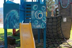 climb the net to the pirate ship and slide back down
